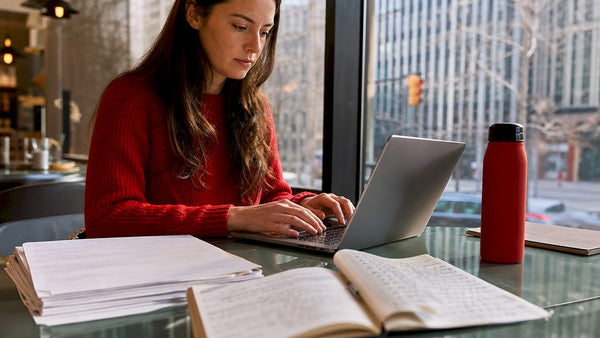 Author typing on laptop in home office