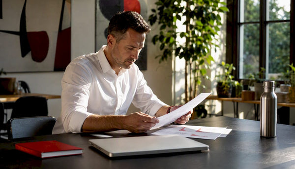 Man reviewing omnichannel CPG reports in meeting room